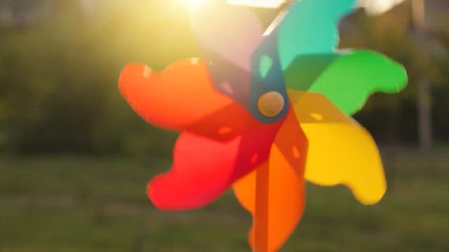 Colorful pinwheel spinning in the sunlight in a garden