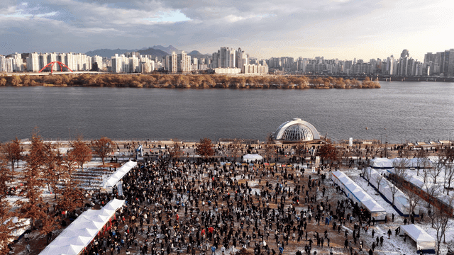 People gathered at winter event by city riverside