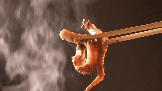 Hot baby octopus lifted with chopsticks
