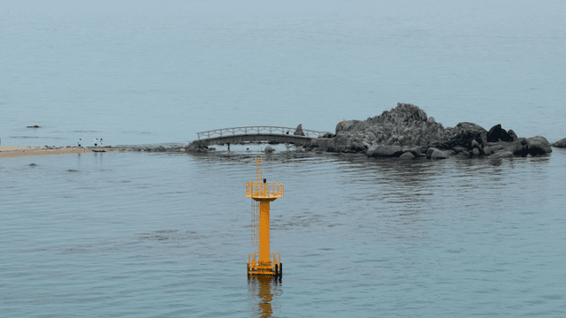Calm sea with a small rocky island
