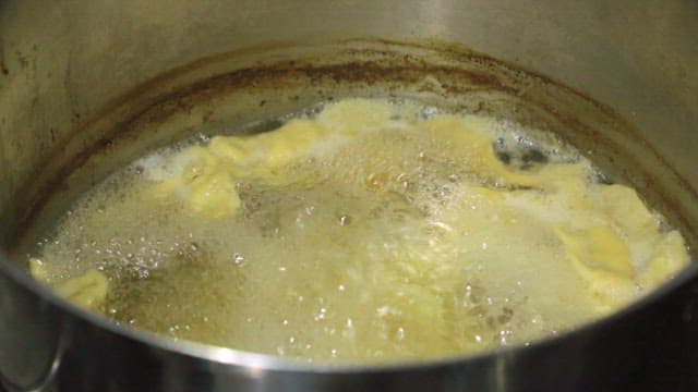 Dough for sujebi in boiling water in a pot