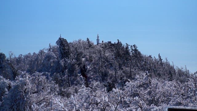 Winter mountains covered with snow and ice under a blue sky