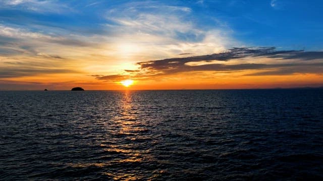 Serene Sunset Over Calm Ocean Waters