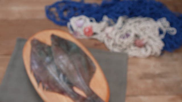 Plate of fresh fish on a wooden table