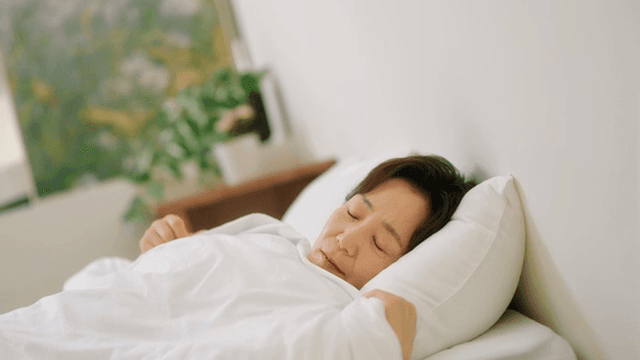 침대에서 평화롭게 잠든 여성