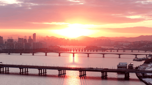Sunset over a city skyline with bridges