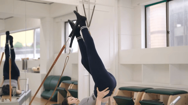 Woman practicing pilates on a reformer