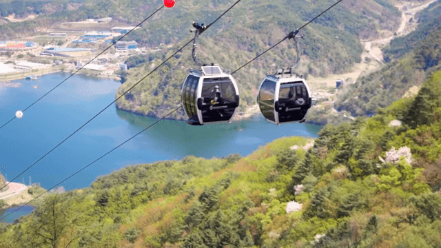 Cable cars over a scenic mountain landscape
