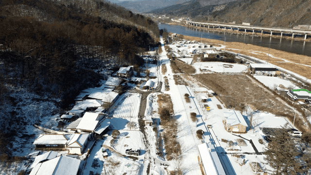 Snow-covered rural village by river