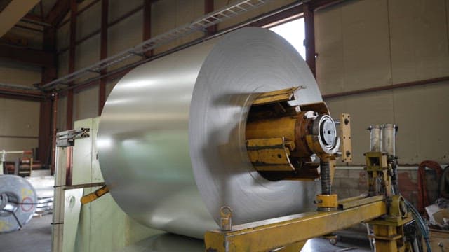 Large metal coil in a factory setting