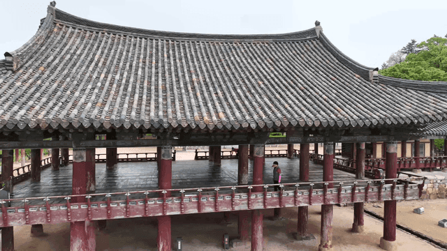 Traditional Korean pavilion by lush greenery