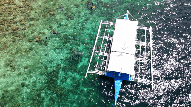 Boat floating on clear turquoise water