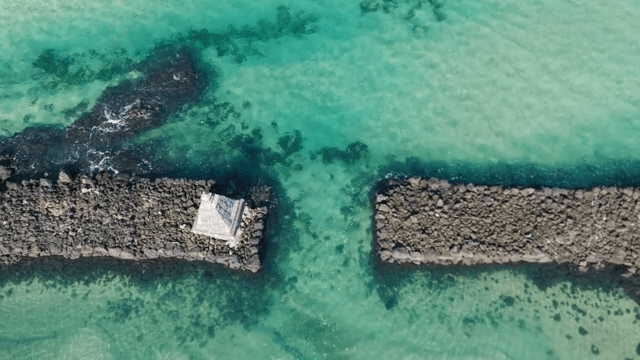 Clear turquoise sea with rocky breakwaters