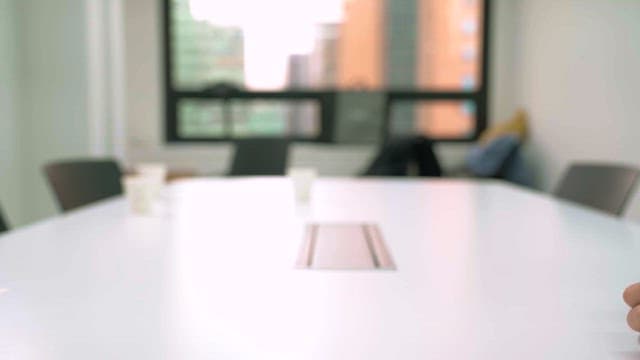 Two people exchanging business cards in an office