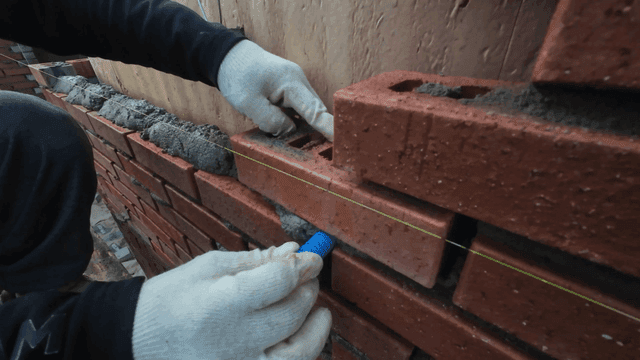 Worker laying bricks accurately