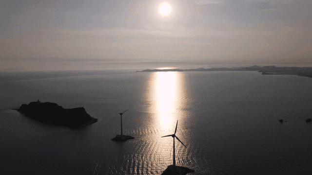 Wind turbines on sunlit sea