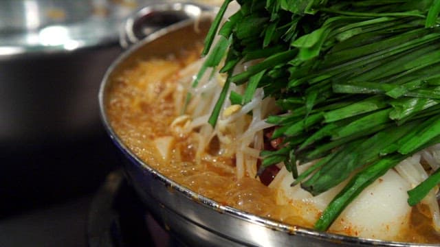 Pork backbone stew topped with chives and bean sprouts