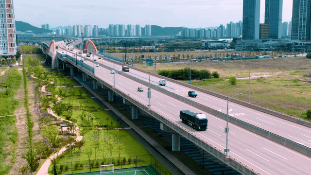 Highway with moving vehicles and city scenery