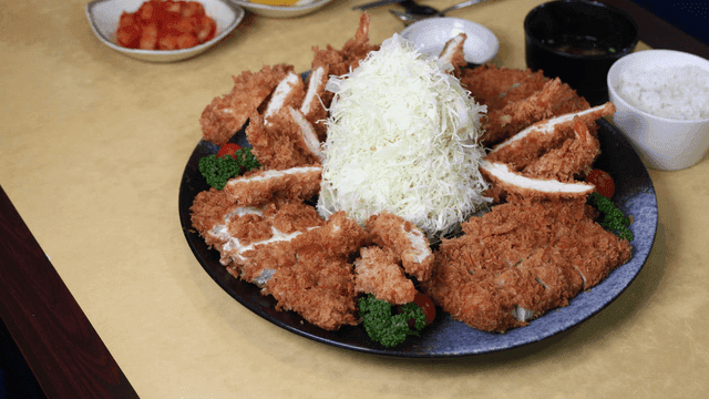 Plate of pork cutlet served with cabbage