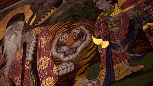 Traditional shamanistic painting depicting a tiger and an immortal