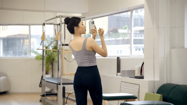 Woman taking a selfie in a fitness studio