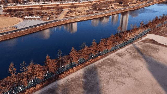 People running on riverside promenade