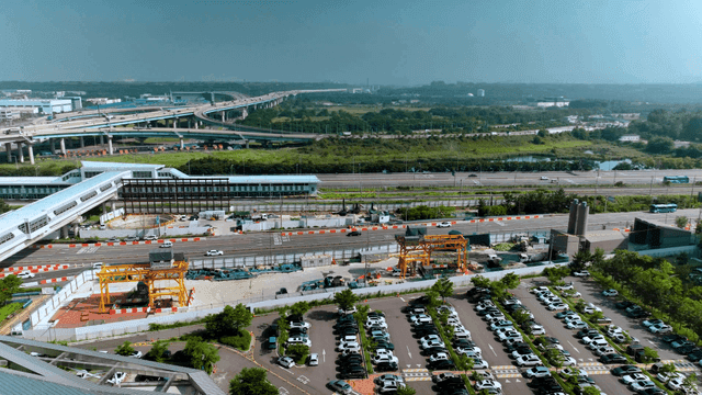 Bustling highway and parking lot scene
