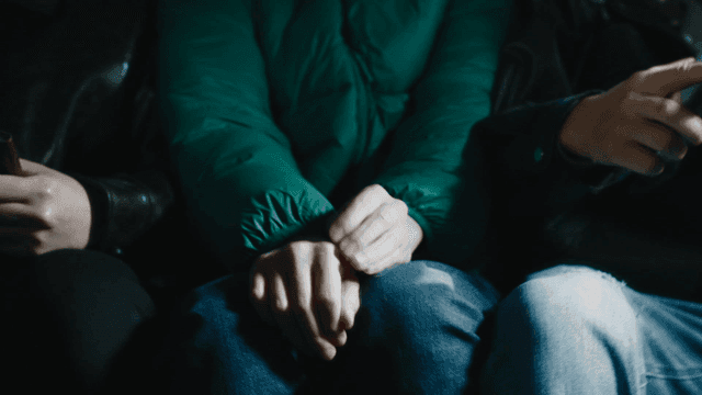 People sitting close together in dark space