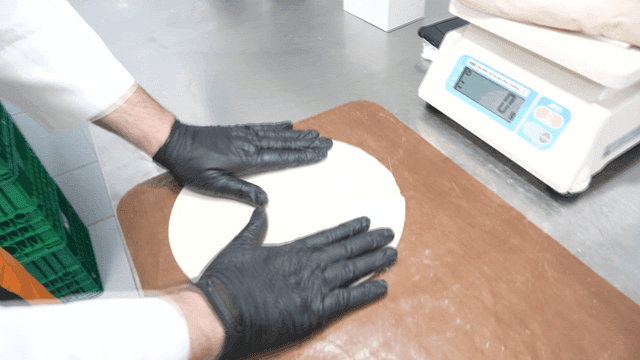 Baker preparing dough in kitchen