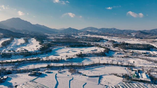 Snow-covered landscape with hills and trees