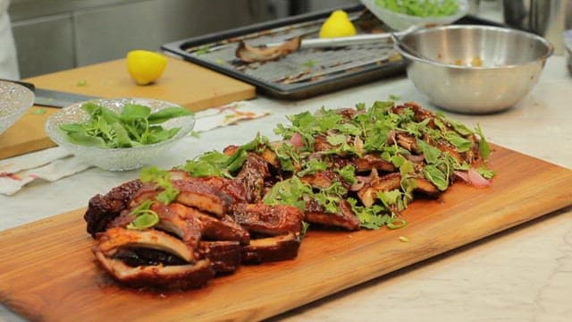 Grilled ribs with herbs on a wooden board