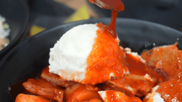 Spicy tteokbokki topped with potato salad