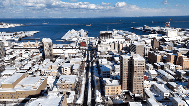 Snow-covered cityscape by the sea