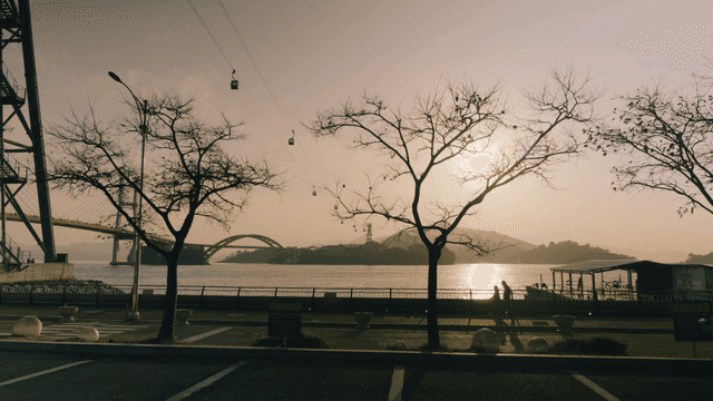 Sunset view of a bridge and cable cars