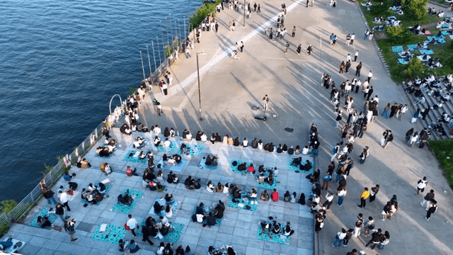 People watching busking on the riverside
