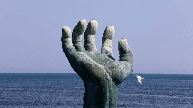 Large hand sculpture in the ocean