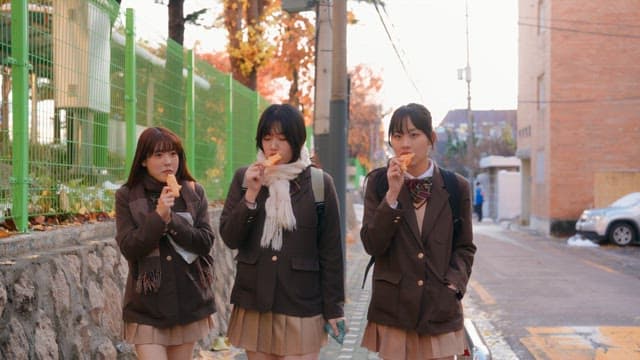 Students eating bungeoppang in winter