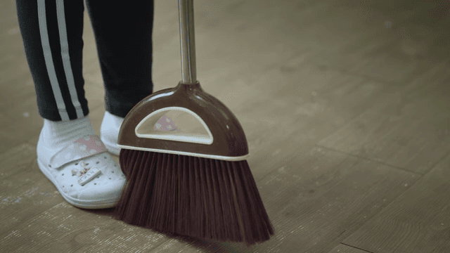 Sweeping the floor with a broom in the classroom