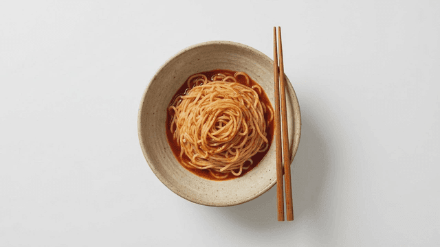Bowl of spicy noodles placed with chopsticks