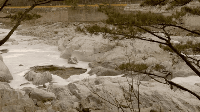 Flowing river with ice and rocks