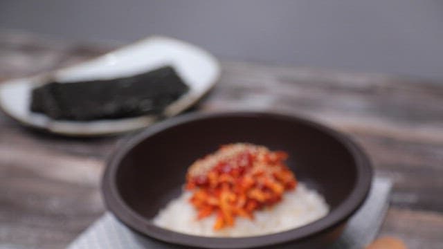 Rice topped with spicy sweet potato salad in a bowl