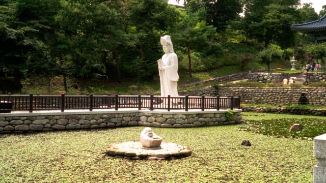 Serene garden with a large Buddha statue