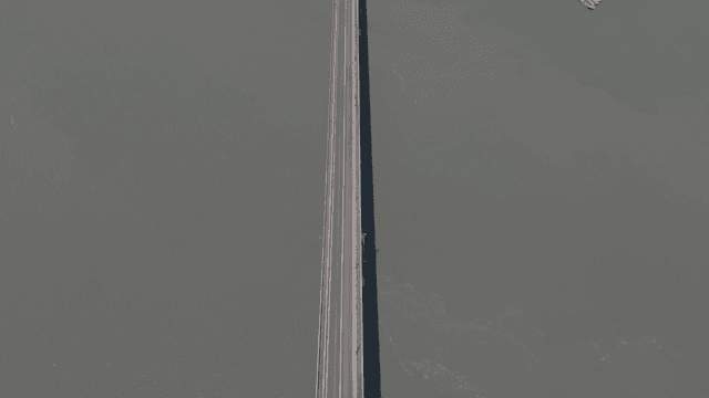 Long bridge stretching over calm water