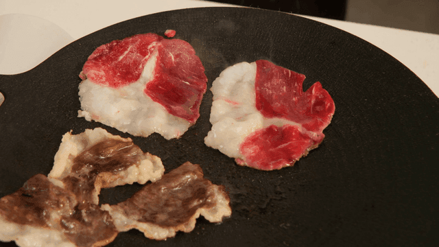 Beef and vegetables sizzling on grill