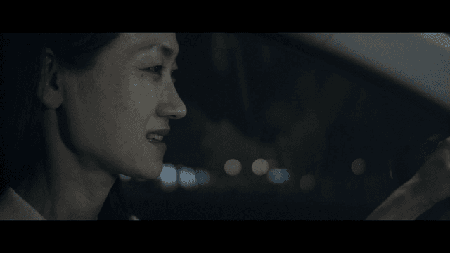 Woman driving at night