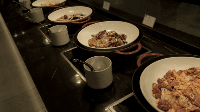 Various dishes displayed on a buffet counter
