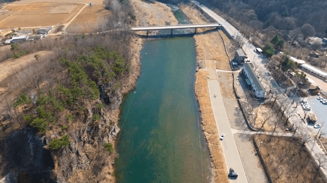Bridge over a clear river with rocky cliffs