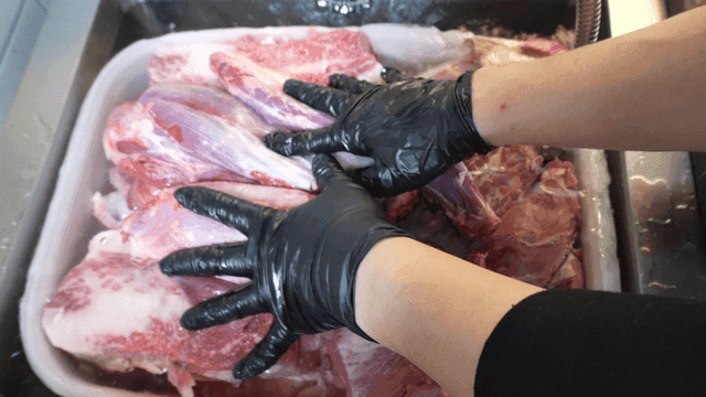 Raw meat soaking in kitchen sink water