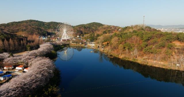 Scenic riverside with mountains and cherry blossoms in spring