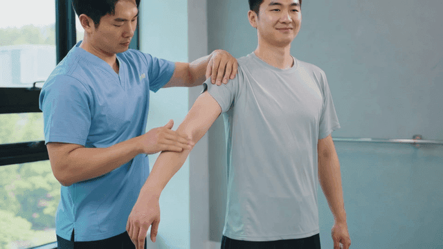 Physical therapist touching patient's arm